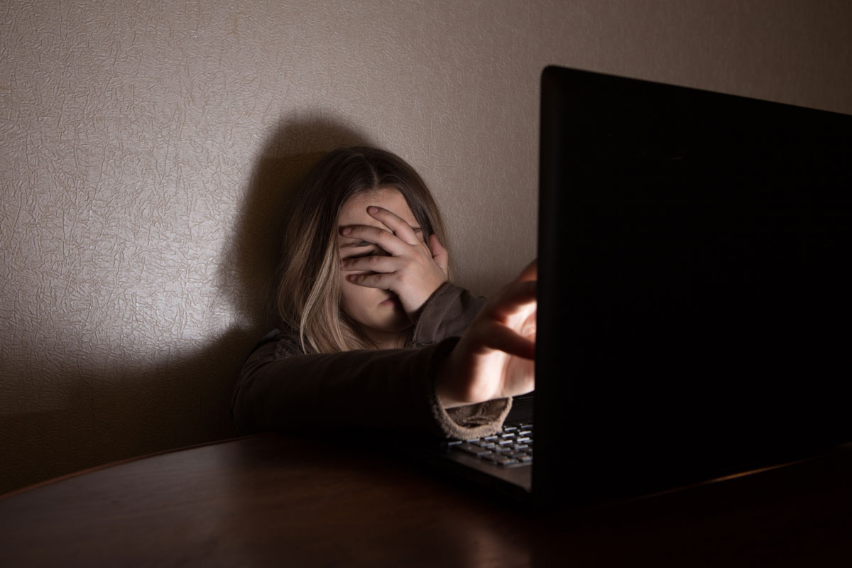 girl crying because of cyberbullying